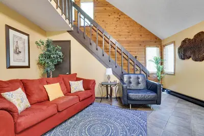 a living room with a red couch and a blue chair at Chalet renovated Near Casino, Camelback , Kalahari 4bdrms firepit hot tub game room in Tobyhanna