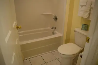 a bathroom with a toilet and a bath tub and a toilet at Top Hill Motel in Saratoga Springs