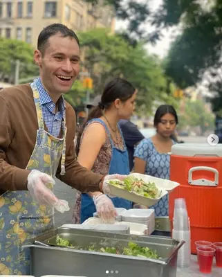 a man is preparing food in a food truck at Interfaith Retreats in New York