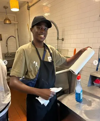 a young man in a kitchen preparing food at Interfaith Retreats in New York