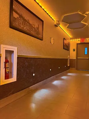 a room with a hallway with lights on the wall at Umbrella Hotel Bronx in Bronx