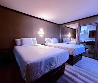a hotel room with two beds and a window at Umbrella Hotel Bronx in Bronx