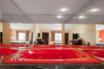 a red bath tub in a room with at Travelodge by Wyndham Jersey City in Jersey City