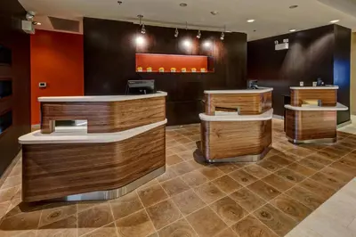 a barber shop with wooden walls and brown floors at Courtyard by Marriott Westbury Long Island in Westbury