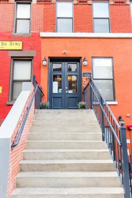 a staircase leading to a blue door on a building at The Park Ave North in New York