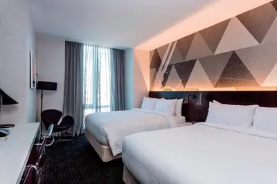 a hotel room with two beds and a window at Courtyard by Marriott Long Island City/New York Manhattan View in Queens
