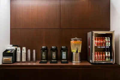 a shelf with a drink and a blender on it at Courtyard by Marriott Long Island City/New York Manhattan View in Queens