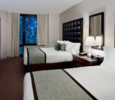 a hotel room with two beds and a window at Distrikt Hotel New York City, Tapestry Collection by Hilton in New York