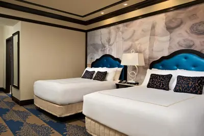 a hotel room with two beds and a mural at Saratoga Casino Hotel in Saratoga Springs