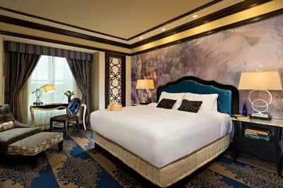 a bedroom with a large bed and a desk at Saratoga Casino Hotel in Saratoga Springs