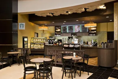 a restaurant with tables and chairs and a bar at Saratoga Casino Hotel in Saratoga Springs