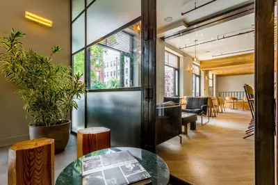 a meeting room with a table and chairs in a building at Franklin Guesthouse in Brooklyn
