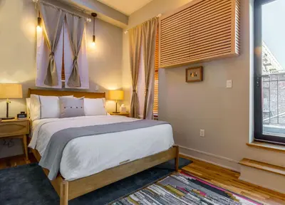 a bedroom with a large bed and a window at Franklin Guesthouse in Brooklyn