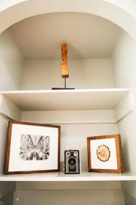 a shelf with two pictures and a camera on it at Franklin Guesthouse in Brooklyn