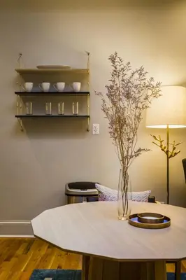 a table with a vase of flowers on top of it at Franklin Guesthouse in Brooklyn