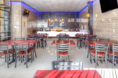 a dining room with tables and chairs in a restaurant at LIC Hotel in Queens