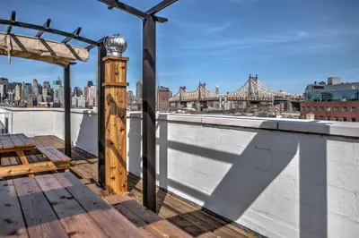 a rooftop deck with a view of the city at LIC Hotel in Queens