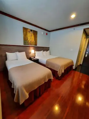 a hotel room with two beds in a room at LIC Hotel in Queens