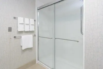 a glass shower in a bathroom with white towels at Holiday Inn Express Southington by IHG in Southington