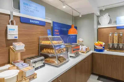 an apple store with a bakery with bread on a counter at Holiday Inn Express Southington by IHG in Southington