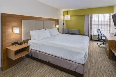 a hotel room with a large bed and a desk at Holiday Inn Express Southington by IHG in Southington