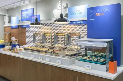 a bakery with a display of pastries on a counter at Holiday Inn Express Southington by IHG in Southington