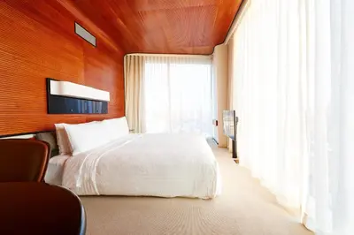 a bedroom with a white bed and a large window at The Standard, High Line New York in New York