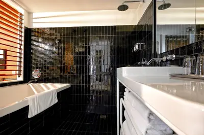 a bathroom with a tub and a sink at The Standard, High Line New York in New York