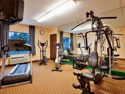a gym with cardio equipment in a hotel room at Baymont by Wyndham East Windsor Bradley Airport in East Windsor