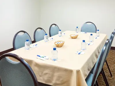 a table with chairs and bottles of water on it at Baymont by Wyndham East Windsor Bradley Airport in East Windsor