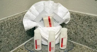 a group of three bottles on a counter with towels at Baymont by Wyndham East Windsor Bradley Airport in East Windsor