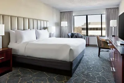 a hotel room with a large bed and a desk at DoubleTree by Hilton Fairfield Hotel & Suites in Fairfield