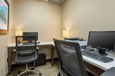 an office with a desk with a computer and a chair at Best Western Plus Kingston Hotel and Conference Center in Kingston