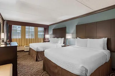 a hotel room with two beds and a television at Best Western Plus Kingston Hotel and Conference Center in Kingston