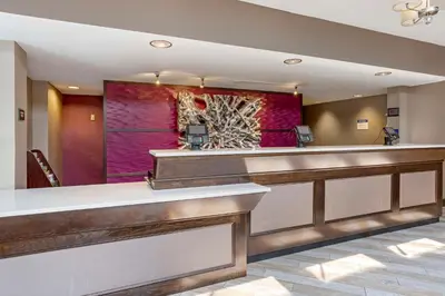a lobby of a hotel with a reception desk at Best Western Plus Kingston Hotel and Conference Center in Kingston