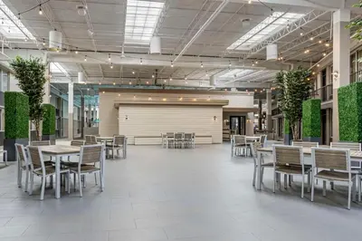 a dining room with tables and chairs in a building at Best Western Plus Kingston Hotel and Conference Center in Kingston