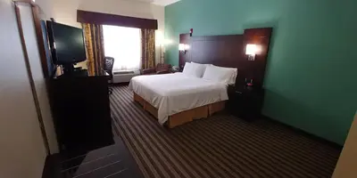 a hotel room with a bed and a flat screen tv at Holiday Inn Express Hotel & Suites West Point-Fort Montgomery by IHG in Fort Montgomery