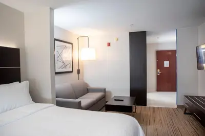 a hotel room with a bed and a couch at Holiday Inn Express Hotel & Suites Chester by IHG in Chester