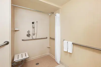a bathroom with a shower and a toilet at Hampton Inn New York - LaGuardia Airport in Queens