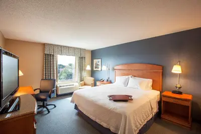 a hotel room with a bed and a flat screen tv at Hampton Inn New York - LaGuardia Airport in Queens