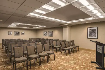 a room with a bunch of chairs in it at Hampton Inn New York - LaGuardia Airport in Queens