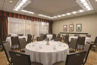 a conference room with a table and chairs at Hampton Inn New York - LaGuardia Airport in Queens