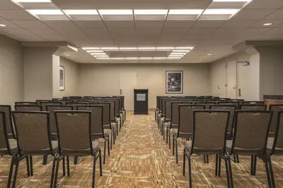 an empty room with rows of chairs in it at Hampton Inn New York - LaGuardia Airport in Queens