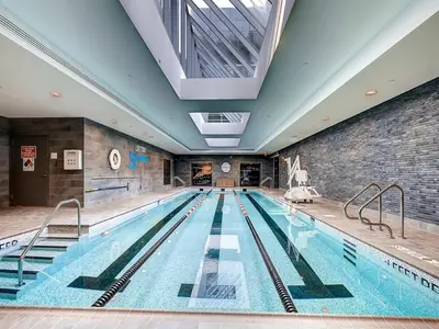a large indoor swimming pool with a large ceiling at Global Luxury Suites at Sky in New York