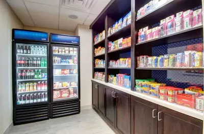 a grocery store aisle with two large refrigerators at Hampton Inn & Suites Springfield Downtown in Springfield