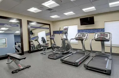 a gym with several treadmills and elliptical machines at Hampton Inn & Suites Springfield Downtown in Springfield
