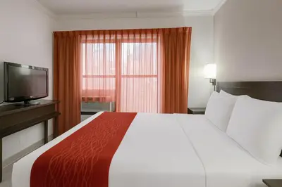 a hotel room with a large bed and a television at Heritage Hotel New York City in New York