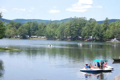 a group of people in boats on a lake at Alpine Lake Lakefront Cabin 5 in South Corinth