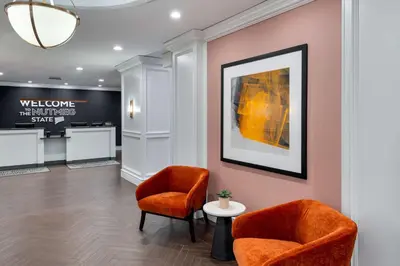 a waiting room with two chairs and a picture at Hampton Inn and Suites Hartford/Farmington in Farmington