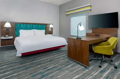 a hotel room with a bed and a desk and a computer at Hampton Inn and Suites Hartford/Farmington in Farmington
